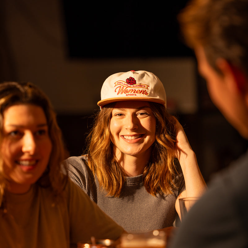 Devon wearing The Sports Bra x yello hat