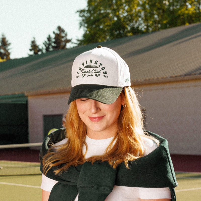 Irvington Club x yello hat on a Portland tennis court